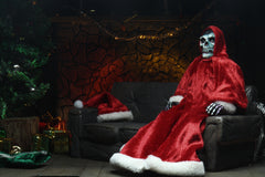 Skeleton in red Santa costume seated in chair from Misfits Holiday Fiend action figure