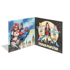 Open book display of comic-style female characters in Osaka Popstar American Legends expanded edition